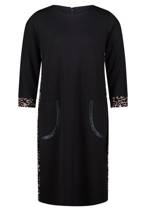 Black dress with three-quarter sleeves, featuring leopard print accents on the cuffs and sides, and two large patch pockets.