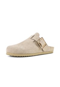 Beige suede slip-on shoe with a rounded toe, adjustable gold-tone buckle, and a textured rubber sole. Smooth surface with minimal accents.