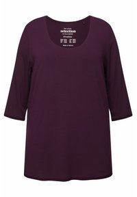 Paarse lange mouwen t-shirt met een rond decolleté, gemaakt van zachte stof. Bevat een eenvoudig ontwerp, zonder patronen of versieringen.