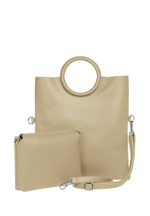 Beige leather tote bag with circular handle, textured surface, and a detachable pouch. Includes silver hardware and a removable strap.