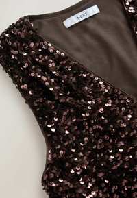 Sequined brown top featuring a deep V-neckline, embellished with pink circular sequins and a smooth inner lining labeled "NEXT."