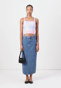 Crochet-style, pastel pink and blue cropped top, high-waisted denim maxi skirt, black handbag, and black flats.