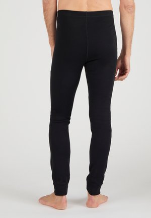 Schwarze Baumwollleggings mit einer enganliegenden Passform und elastischem Bund, die eine glatte Textur und keine sichtbaren Nähte oder Muster aufweisen.