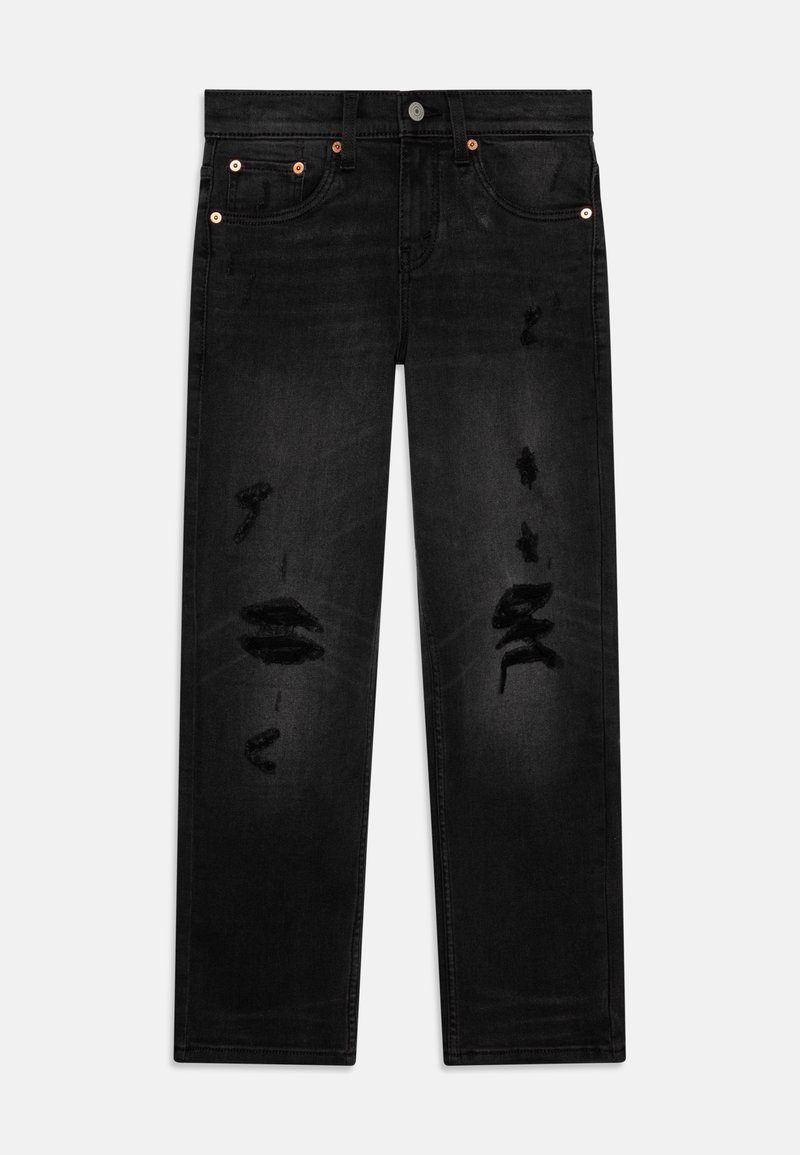 Jean noir coupe droite avec des détails usés sur l'avant des cuisses et des rivets en cuivre sur les poches, posé à plat sur un fond clair.