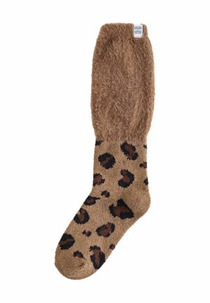 Braun-flauschige Socke mit einem Leopardenmuster auf einem cremefarbenen Grund. Weicher Stoff, knöchelhoch und mit einem gerippten Saum.