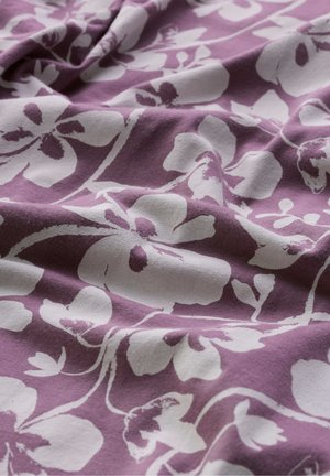 Tela morada con patrón de flores blancas, mostrando pliegues suaves y textura.