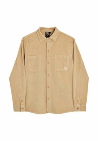 Chemise en velours côtelé beige avec un col boutonné, deux poches poitrine et un logo discret sur la poche gauche. Tissu côtelé texturé.