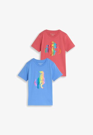 Zwei kurzärmlige Kinder-T-Shirts mit einem regenbogenfarbenen Dinosaurier auf blauem Shirt und einem regenbogenfarbenen Monstertruck auf rotem Shirt.