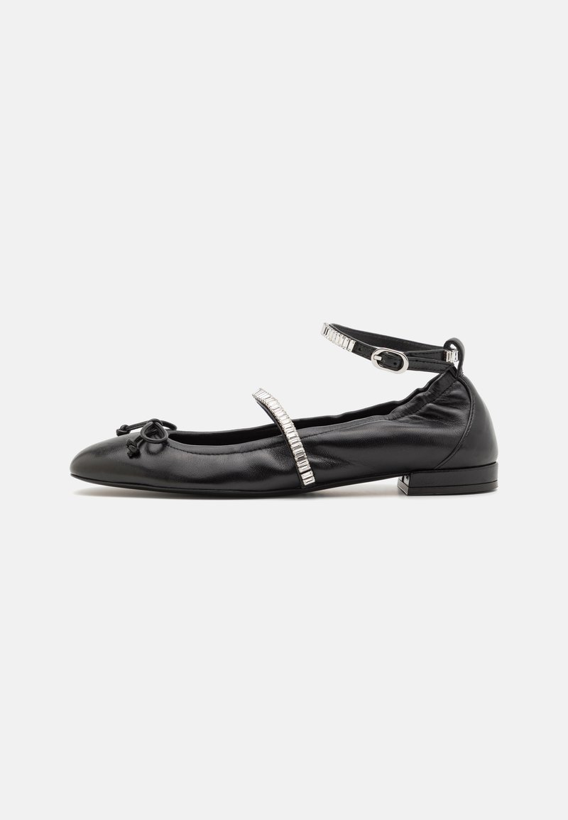 Black leather ballet flat with a rounded toe, decorative bow, and a strap featuring clear beading. Low heel and smooth texture.