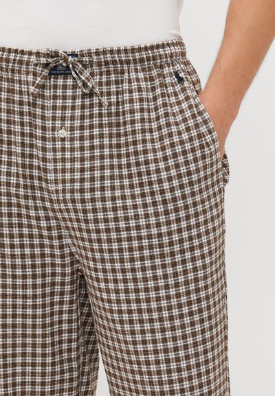 Bruin en wit geruit pyjamabroek met een elastische tailleband, koord en zijzakken. Textiel met een ontspannen pasvorm.