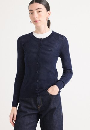Navy ribbed cardigan with long sleeves and button front, featuring a round neckline and a small logo detail on the chest.