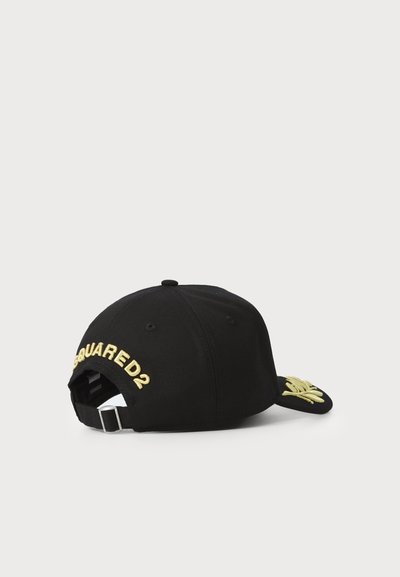 Black baseball cap made of fabric, featuring embroidered gold text "DSQUARED2" on the back and a detailed gold design on the visor.