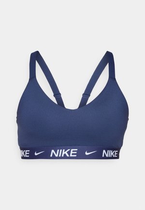 Navy sports bra with a smooth fabric, racerback design, and a wide elastic band featuring white "NIKE" branding.