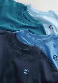 Három crew-neck póló sötét tengerészkék, türkiz és világoskék árnyalatokban. Mindegyiken diszkrét, hímzett logó található a mellkasán.