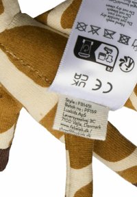 Pehmolelunorsu, jolla on beige vartalo ja ruskeat läiskät, teksturoitu kangas ja hoito-ohjeetiketti sivussa.