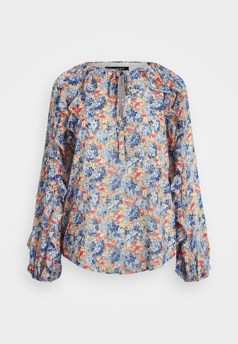Blouse fleurie à manches longues avec détails à volants, col à nouer, et un mélange de bleu, orange, rose et jaune sur un fond clair.