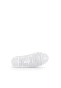White rubber sneaker sole with vertical and horizontal grooves; features logo at the heel and textured grip for traction.