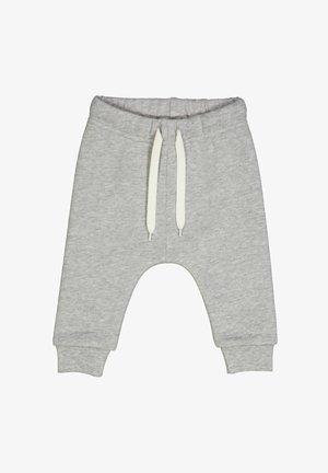 Svetle šedé tepláky vyrobené z měkké látky. Mají elastický pas s bílými šňůrkami a pružné manžety na kotnících.