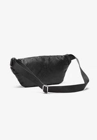 Black fabric bag with a quilted pattern, curved shape, adjustable strap, and metallic hardware. Smooth texture, compact design.