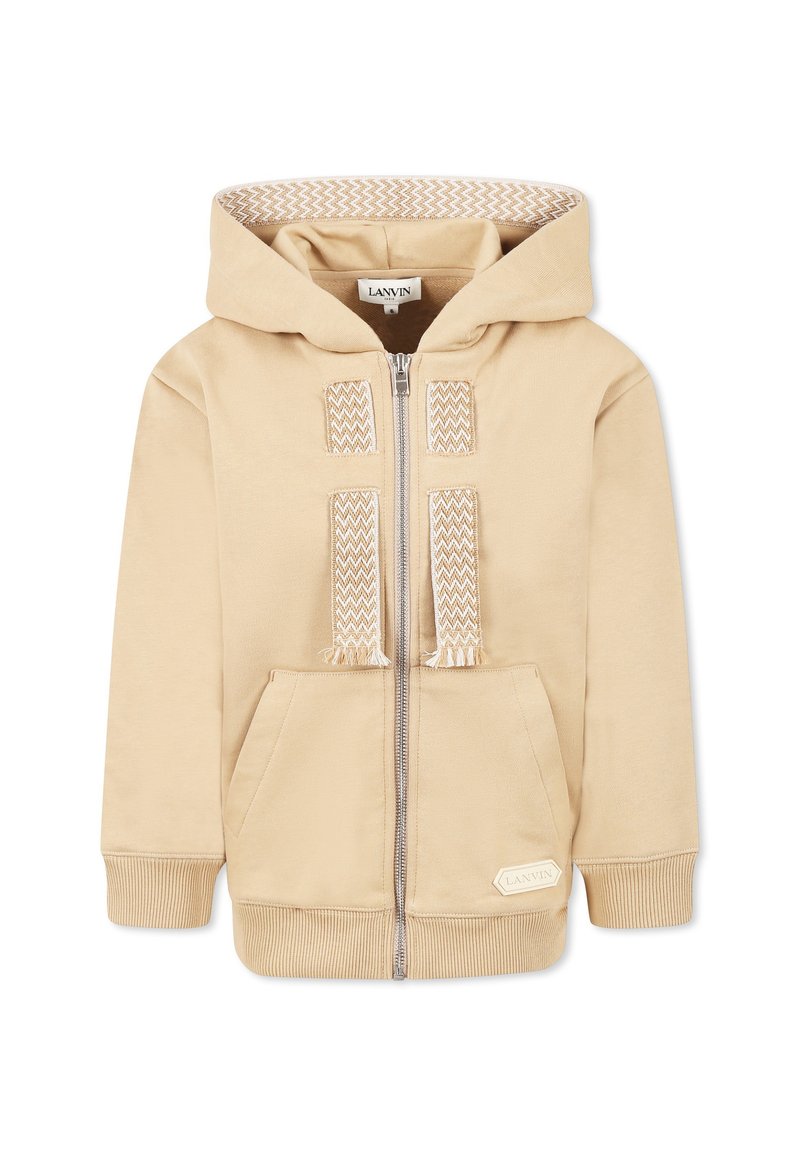 Sweat à capuche beige zippé avec une doublure texturée de la capuche, des poches avant et des accents tissés décoratifs sur la fermeture éclair. Poignets et ourlet côtelés.