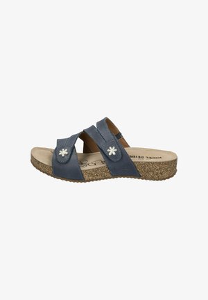 Sandali in pelle blu con due cinturini incrociati, dettagli floreali e suola in sughero testurizzato. La soletta è di un beige chiaro.
