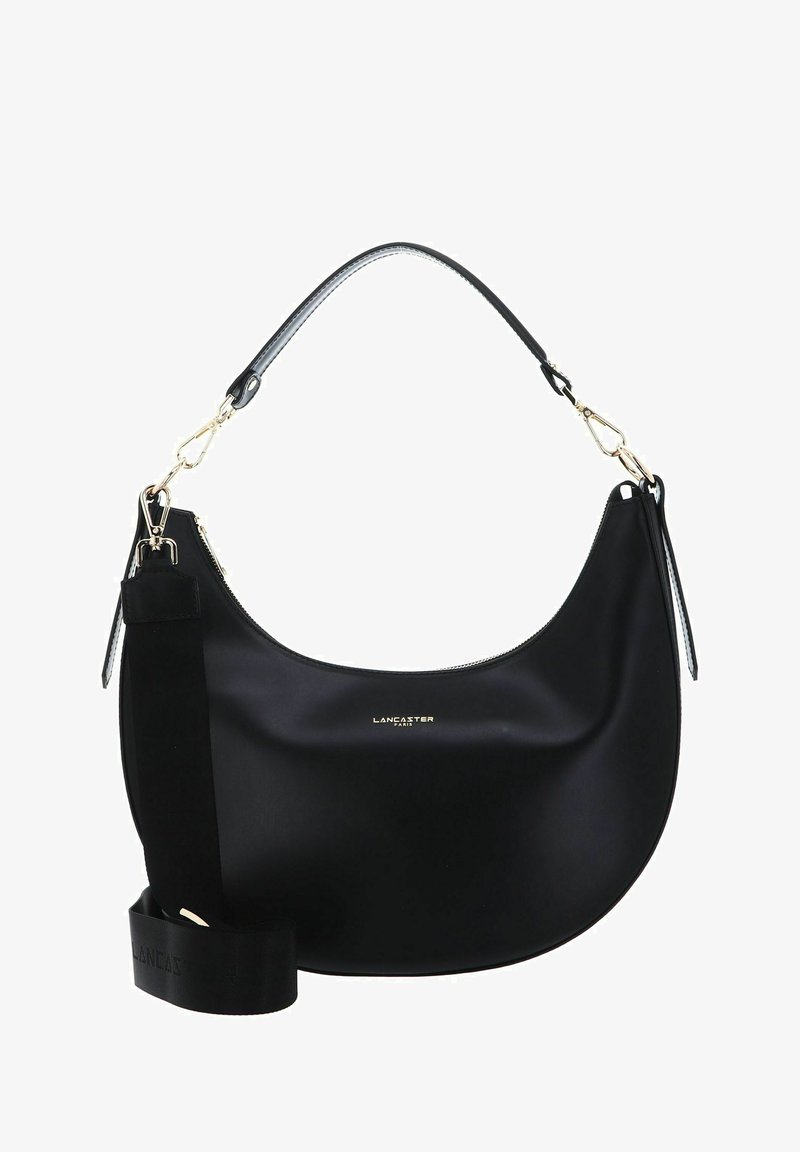 Sac à main noir en matériau lisse avec une forme incurvée. Doté de quincaillerie dorée, d'une bandoulière ronde et d'une sangle épaisse complémentaire.