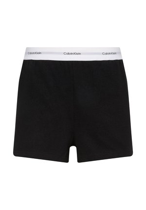 Sort bomuldstrusser med enkel ensfarvet design, der har en hvid elastisk linning med mærket "Calvin Klein." Glat tekstur, mellemlang længde.