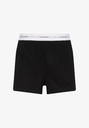 Braga de algodón negra con diseño sólido, con una cinturilla elástica blanca etiquetada "Calvin Klein". Textura suave, corte de longitud media.