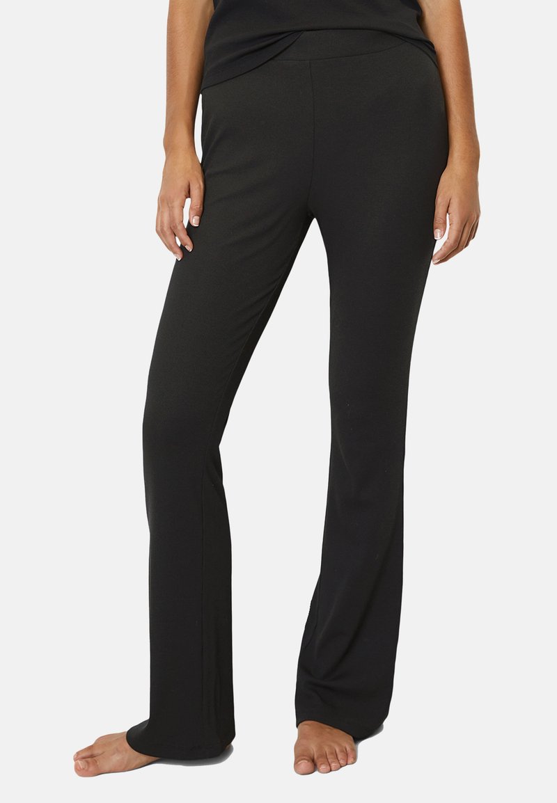 Black, fitted pants with a straight leg design. Made from stretchable fabric, featuring a smooth texture and an elastic waistband.