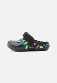 Črne plastične klompe z mehkim črnim trakom, okrašene s pisanimi božičnimi lučkami v modri, zeleni, rumeni in rdeči barvi.