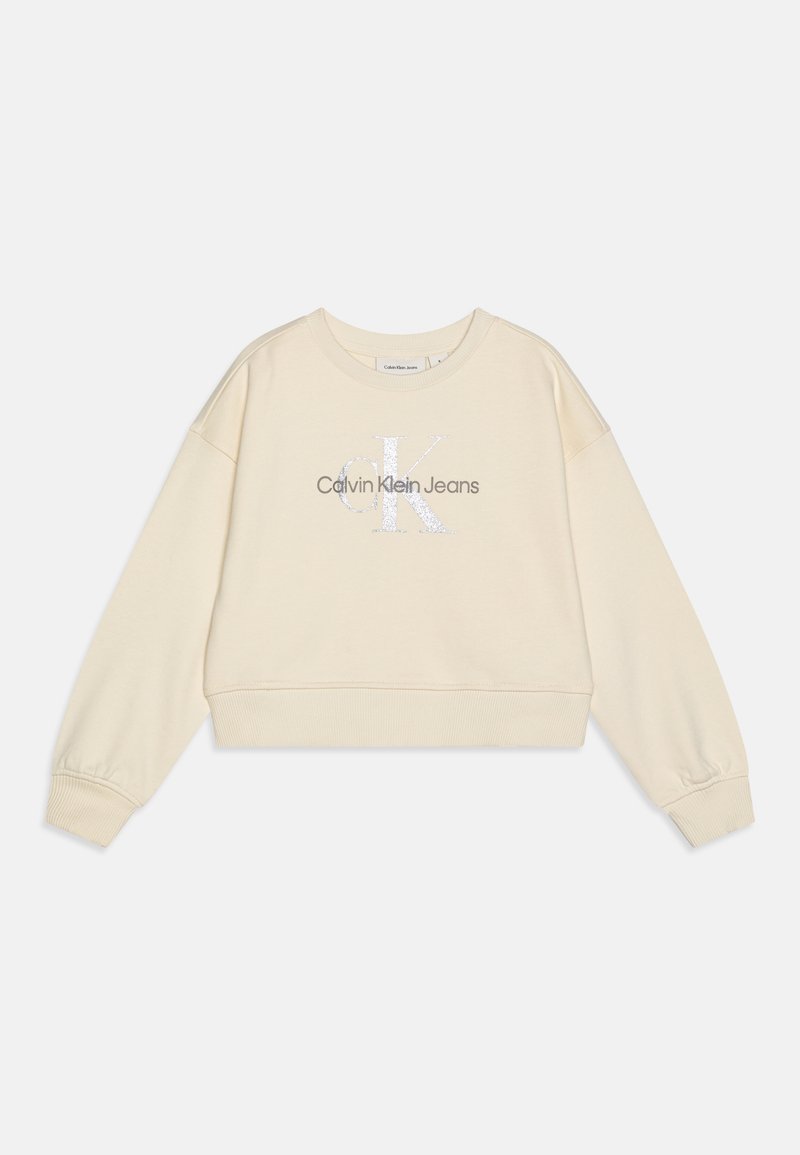 Skraćeni bež dukserica s dugim rukavima, sadrži srebrni logo "Calvin Klein Jeans" na središtu, izrađena od mekanog materijala.