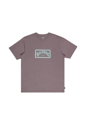 Purple cotton t-shirt featuring a rectangular light blue graphic with "BILLABONG" text and decorative border centered on the front. Short sleeves.