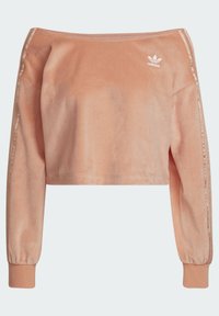 Skraćeni dugi rukavi u mekom breskvaste boje od baršuna s okruglim izrezom, bijelim Adidas logotipom na prsima i rebrastim manžetama.