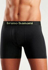 Svarta boxershorts av stretchtyg med ett märkeselastiskt midjeband i neongrönt, släta sömmar och en åtsittande design.