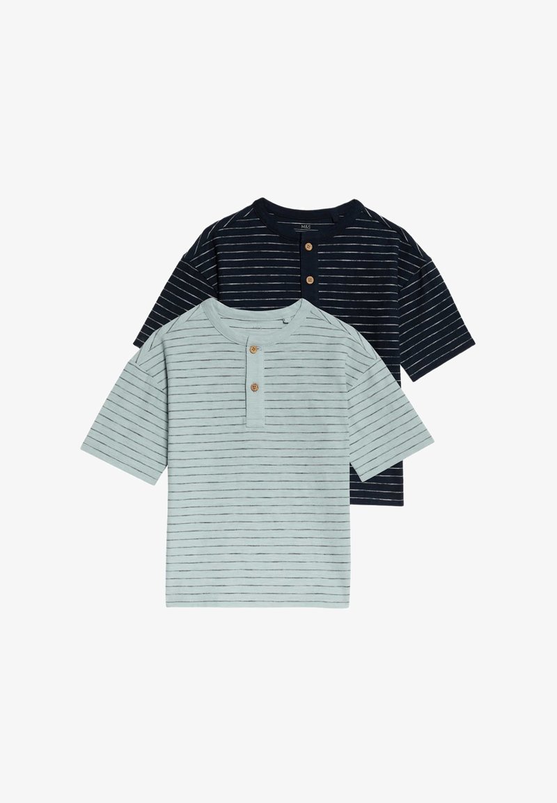 Dvě trička s krátkým rukávem: jedno světle zelené s tenkými tmavými pruhy, druhé tmavě modré s podobnými pruhy. Každé má dřevěné knoflíky na výstřihu.