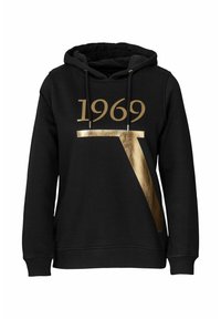 Svart hoodie med guld logotyp "1969" och en geometrisk design. Dragsko i huva, ribbade muddar och nederkant, mjuk textur, avslappnad passform.