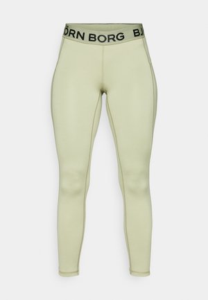 Light green leggings made of stretchy material, featuring a solid design, fitted shape, and a black branded waistband.