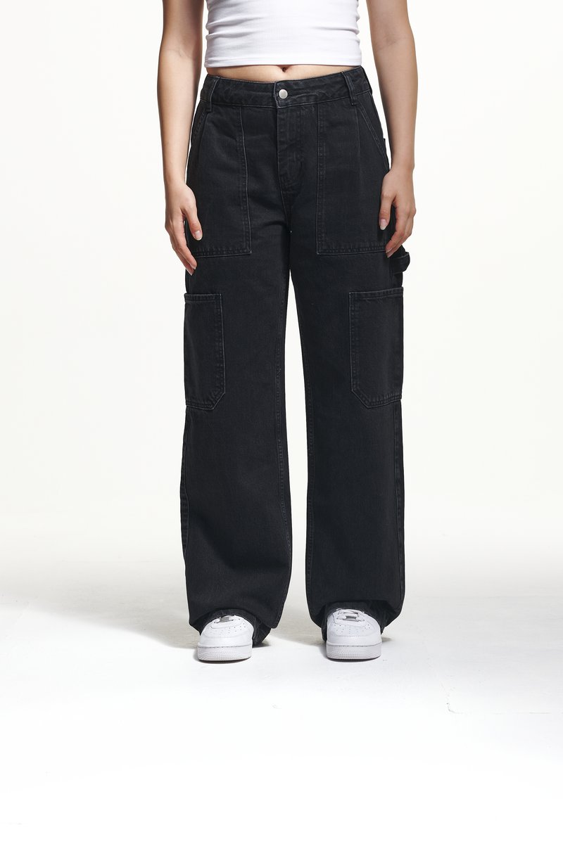 Black cargo pants with wide legs, featuring large front pockets and a high waist design. Made of denim with a smooth texture and contrasting stitching.