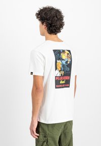 Hvid kortærmet t-shirt med et farverigt grafik på ryggen med teksten "PEARL HARBOR", tegneseriefigurer og tropiske elementer.