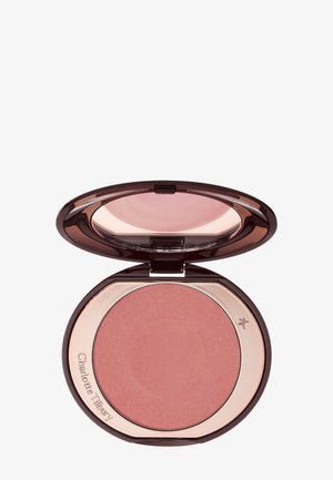 Compact with open mirror showing shimmery rose blush inside a dark brown and rose gold case with "Charlotte Tilbury" engraved.