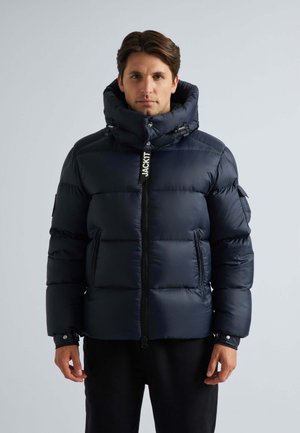 Navy puffer jacket with a high collar and zip closure. Quilted design with elastic cuffs and a branded zipper pull. Smooth, shiny texture.