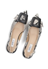 Pointed-toe flats featuring a black and white snake print pattern. Accented with a large black square buckle. Smooth beige insole visible.