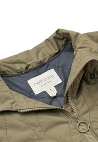 Veste matelassée vert olive avec une tirette de fermeture éclair ronde en métal, montrant la doublure intérieure grise et une étiquette blanche indiquant "rethinkit designed for life."
