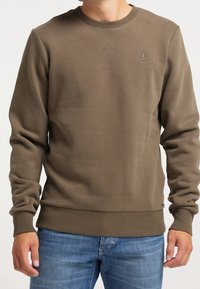 Olive green sweatshirt with a round neck, ribbed cuffs, and hem. Features subtle logo on chest and cross-stitch detailing at neckline.