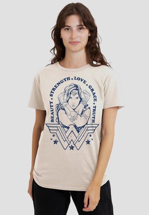 Beige t-shirt featuring a blue graphic of a female superhero with text: "BEAUTY STRENGTH LOVE GRACE TRUTH" and star accents. Short sleeves.