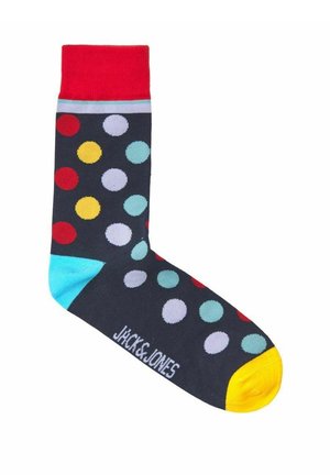 Calzini multicolori con una base blu navy, adornati da grandi pois rossi, gialli e azzurri. Cuffia rossa, tallone turchese e punta gialla.