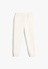 Cremefarbene Sweatpants mit einem elastischen Bund und engeren Bündchen. Glatte Textur mit einem einfachen, geraden Bein-Design.