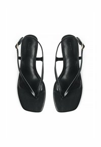 Black leather sandals featuring thin straps, a square toe design, and an adjustable ankle strap with a gold buckle accent.