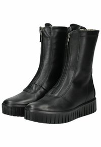 Black leather ankle boots with side zippers, textured finish, flat ridged sole, and a streamlined design. No visible branding or accents.