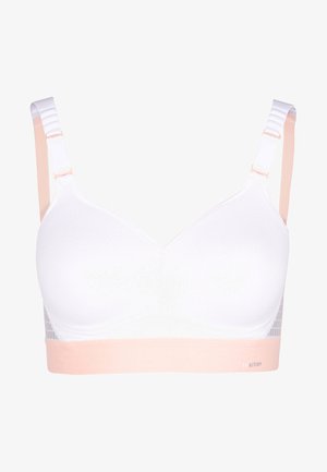 HvitBH med en strukturt mønsterflate, justerbare stropper i lys fersken, og et mykt ferskenfarget bånd nederst med detaljert logo.